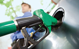 photo of gas pump filling car tank