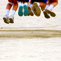 Teamwork: We achieve results through open collaboration where the talents of each team member enable the greater success of the team. Children's feet hanging in midair